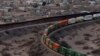 A train travels along the US side close to a portion of the border wall along the U.S.-Mexico border between Cuidad Juarez, Mexico and Sunland Park, New Mexico, as seen from Mount Cristo Rey in El Paso, Texas, Feb. 26, 2025. 
