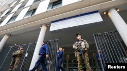 军人持枪守卫在布鲁塞尔一处法庭外,巴黎袭击事件的嫌疑人预计将在这里接受讯问。(2015年11月16日)