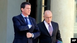 2015年4月22日法国总理曼努埃尔·瓦尔斯(左)和内政部长卡泽纳夫内阁会议后离开爱丽舍宫