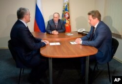 Russian President Vladimir Putin, center, meets with Crimean leader Sergei Aksyonov, left, and acting Sevastopol governor Dmitry Ovsyannikov, while visiting the youth educational forum 'Tavrida' in the Bakal Spit in Crimea, Aug. 19, 2016.