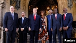 资料照:2019年3月22日,在美国佛罗里达州棕榈滩特朗普的海湖庄园,时任美国总统特朗普和第一夫人梅拉尼娅在与圣卢西亚总理艾伦·查斯塔内、多米尼加共和国总统达尼洛·梅迪纳、牙买加总理安德鲁·霍尔内斯、海地总统约韦内尔·莫伊兹和巴哈马总理休伯特·明尼斯在会晤前合影。