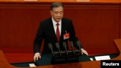 全国政协主席汪洋在中国政协年度会议上作工作报告。(2021年3月4日)