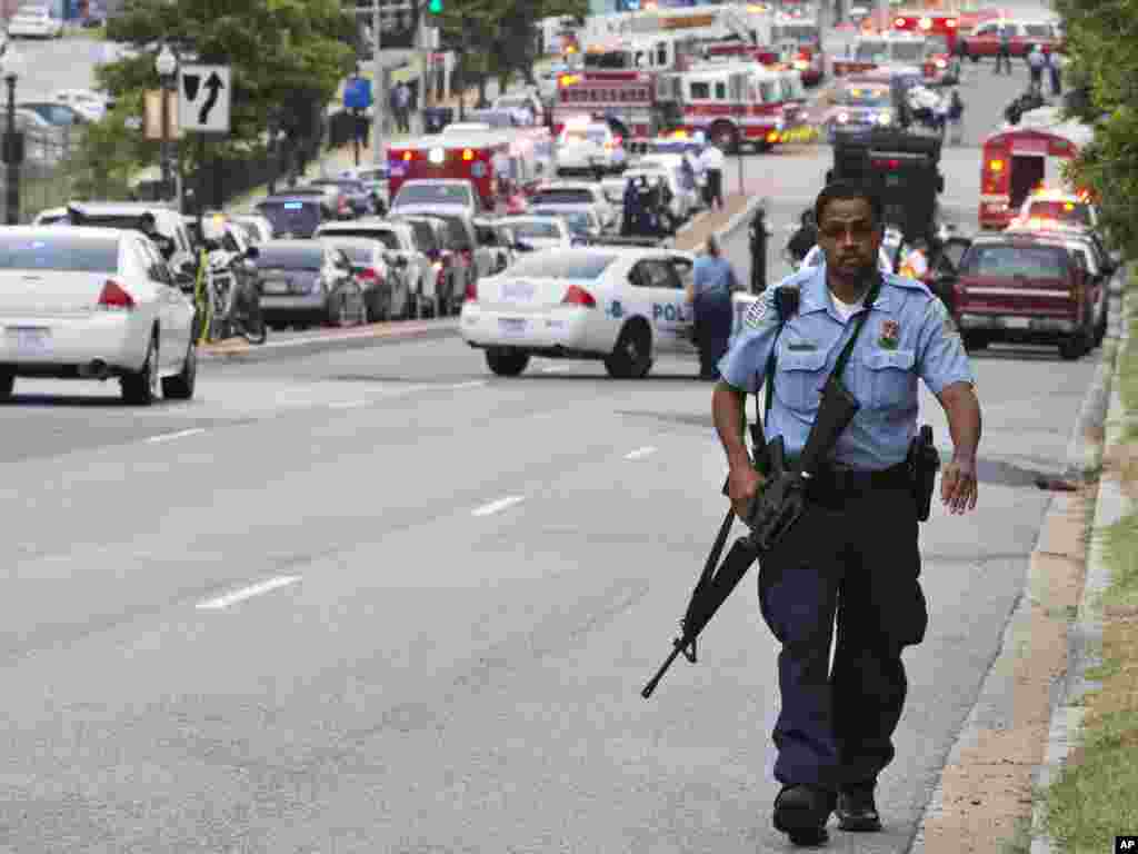 A Metropolitan Police Department officer walks near the Washington Navy Yard, Sept. 16, 2013.