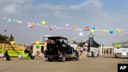 A photographer on a  Ferris wheel catches the image of he Earth's shadow crossing the moon during a total lunar eclipse in Tokyo, Japan, Oct. 8, 2014.