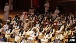 FILE - Members of the Taliban delegation attend the opening session of the peace talks between the Afghan government and the Taliban in the Qatari capital Doha, Sept. 12, 2020.