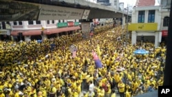 Protesters occupy a street during a rally in downtown Kuala Lumpur, Malaysia, Saturday, Nov. 19, 2016. Tens of thousands of yellow-shirt protesters rallied Saturday in Kuala Lumpur seeking Malaysian Prime Minister Najib Razak's resignation over a financial scandal, undeterred by a police ban and the arrest of more than a dozen activists.