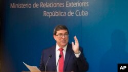 A boy make heart sign while the last sunset of 2020 hangs over the Sindh's provincial capital of Karachi, Pakistan.