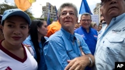 Venezuelan National Assembly President Henry Ramos Allup, center, takes part in a protest march in Caracas, Venezuela, July 27, 2016.