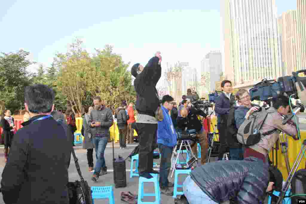 A 13-month-old chimp named Fumo carries a Christmas present of food treats in wrapping paper under his arm during a Christmas-themed feeding time at Sydney's Taronga Park Zoo, Australia.