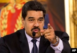 FILE - Venezuelan President Nicolas Maduro, shown in April, promises a harsh response to any coup attempt.