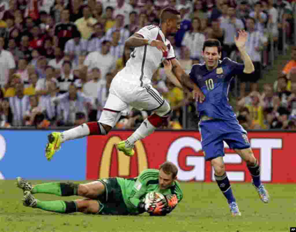 Germany's Jerome Boateng leaps over goalkeeper Manuel Neuer to block Argentina's Lionel Messi after Neuer's save on Messi during the World Cup final soccer match between Germany and Argentina at the Maracana Stadium in Rio de Janeiro, Brazil, Sunday, July