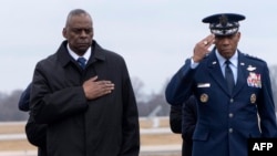 美国国防部长劳埃德·奥斯汀(左)和参谋长联席会议主席小查尔斯·布朗在多佛空军基地出席在约旦美军前哨基地无人机袭击中丧生的三名美国军人遗体的庄严转移仪式。