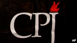 FILE - The CPJ logo is seen on a banner at a media conference in Brussels, Sept. 29, 2015.