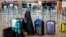 Passengers' luggage is on the floor at the Berlin-Brandenburg airport, during the airports warning strike, March 10, 2025