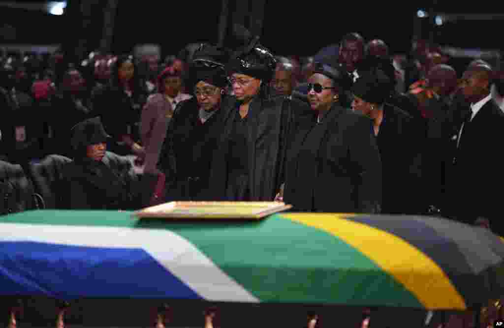 Winnie Madikizela-Mandela, left, Nelson Mandela's former wife, left and Nelson Mandela’s widow Graca Machel stand over the former South African president's casket during his funeral service in Qunu.