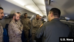 美国海军资料照片:分配入美国海军巡逻第5中队的战术协调员杨帆(右,音译)上尉在P-8A“海神”反潜飞机上向沙特皇家海军人员展示飞机的系统(2018年3月1日)。