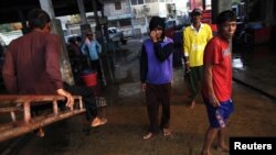 Công nhân di trú Miến Điện vừa rời thuyền đánh cá tại khu chợ hải sản trong thị trấn Mahachai của Thái Lan