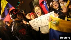 Venezuelans living in Peru protest outside the Venezuela embassy in Lima, demanding a referendum to remove Venezuela's President Nicolas Maduro, Sept. 1, 2016.
