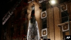 消防队员在纽约市布朗克斯区一处失火的公寓楼救火。(2017年12月28日)