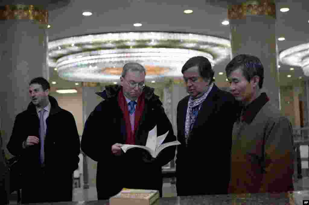 2013年1月9日,谷歌执行董事长施密特与前美国墨西哥州州长理查森在平壤人民大学习堂翻阅一本信息技术教材。