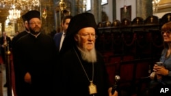 FILE - Ecumenical Patriarch Bartholomew I, the spiritual leader of the world's Orthodox Christians, leaves the Patriarchal Church of St. George, following Sunday services in Istanbul, Oct. 7, 2018.