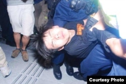 学民思潮召集人黄之锋被胡椒喷雾喷中倒地,被警员铐手铐拾走(张洁平微信图片)