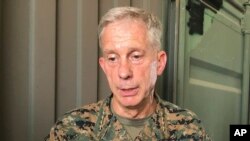 Gen. Thomas D. Waldhauser, left, commander of U.S. Africa Command, is joined by U.S. Ambassador to Senegal Tulinabo S. Mushingi, right, after a tour of Camp Cisse where the U.S. maintains a small site in Dakar, Senegal, July 30, 2018.