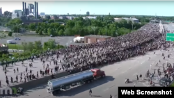 MINNEAPOLIS-- A crowd of protesters part as a tanker truck driven by Bogdan Vicherko barrels towards them. Vicherko was initially arrested under suspicion of assault, but claimed he had no intention to harm anyone.