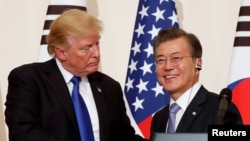 韩国总统文在寅在首尔青瓦台举行的记者会上与到访的美国总统川普握手。(2017年11月7日)