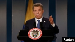 FILE - Colombia's President Juan Manuel Santos talks during a news conference after a meeting with former Colombian President Alvaro Uribe at Narino Palace in Bogota, Colombia, Oct. 5, 2016.