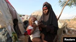A devotee is smeared with a vermillion powder while celebrating the "Sindoor Jatra" vermillion powder festival at Thimi, in Bhaktapur, Nepal.