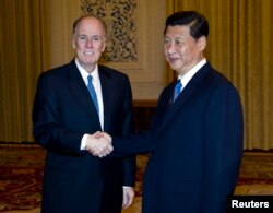 2012年7月25日，美国总统奥巴马的国家安全顾问多尼隆（Tom Donilon）在北京人民大会堂同中国国家副主席习近平握手