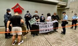 游行起步前警方拉起封锁线，搜查4名游行人士的随身物品，又记录身分证等个人资料 (美国之音/汤惠芸)