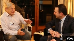 美国索罗斯基金会创始人索罗斯(左)2014年1月在世界经济论坛和格鲁吉亚总理会晤