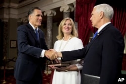 随着第116届国会开始工作,在参议院的一次模拟宣誓仪式上,副总统彭斯与参议员罗姆尼握手。