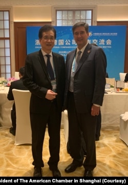 美国商会上海分会会长季恺文(右)出席第三届中国国际进口博览会,与参展的美商代表合影。(美国商会上海分会会长季恺文提供)