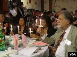 国际特赦组织中国专员齐摩门( 右一 )点起蜡烛纪念六四(美国之音容易拍摄)