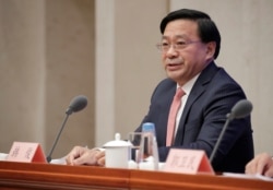 资料照:美中贸易谈判中方团队成员、中国农业部副部长韩俊在北京出席相关美中贸易谈判的记者会。 (2019年12月13日)