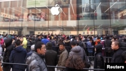 在沈阳的苹果专卖店外面,顾客等待商店开门(2015年2月28日)