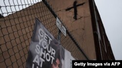 A sign asks people to get the COVID vaccine in a Brooklyn neighborhood which is witnessing a rise in COVID-19 cases on July 13, 2021, in New York City.