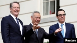 美中两国在华盛顿举行贸易谈判之前,中国副总理刘鹤与美国贸易代表莱特希泽(左)和财政部长姆努钦向媒体示意(2019年10月10日)。