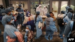 Công dân Việt Nam được hồi hương từ Vũ Hán về tới sân bay Vân Đồn, Quảng Ninh, ngày 10/2/2020. Hàng chục quan chức các bộ đã bị bắt giữ vì nhận và đưa hối lộ hàng chục tỷ đồng trong vụ các "chuyến bay giải cứu."