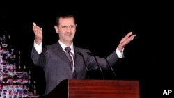 Tổng thống Syria Bashar al-Assad đọc diễn văn đầu tiên kể từ tháng 6 tại nhà hát lớn ở trung tâm thủ đô Damascus, ngày 6/1/2013.