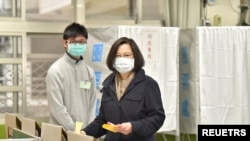 台湾总统蔡英文2021年12月18日在新北市四大公投投票中投下自己的一票。(路透社照片)