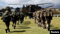 英国陆军士兵和日本陆上自卫队成员在日本的一个陆上自卫队训练营地举行首次联合军演。(2018年10月2日)