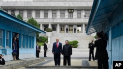 President Donald Trump meets with North Korean leader Kim Jong Un at the border village of Panmunjom in the Demilitarized Zone, South Korea, June 30, 2019.