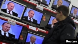 A fragment of the artwork 'Honour' from the series 'Five Elements of War', created by Ukrainian artists Daniel Green and Daria Marchenko, is on display at a studio in Kyiv. The artwork is made of bullet and shell cartridges from the frontline of a military conflict in eastern Ukraine, shoulder straps and other military items.