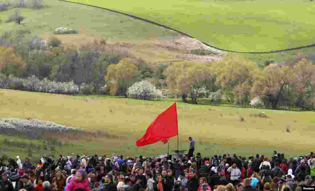 People gather after a costumed reenactment dedicated to the 70th anniversary of the liberation of Simferopol from fascist troops during the World War II outside the village of Kurtsy, near Simferopol, Crimea, April 13, 2014. 