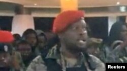 FILE PHOTO: A man in military fatigues speaks inside the Palace of the Nation during an attempted coup in Kinshasa