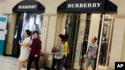 顾客走出英国奢侈品制造商博伯利(Burberry)在上海开设的分店。(资料照)